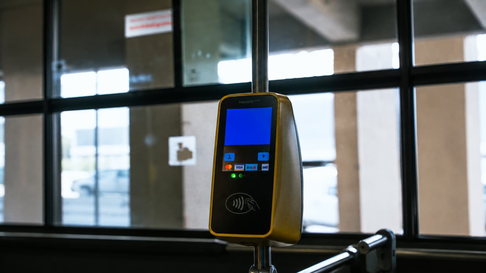 NFC contactless payment terminal on public transport accepting card and phone taps
